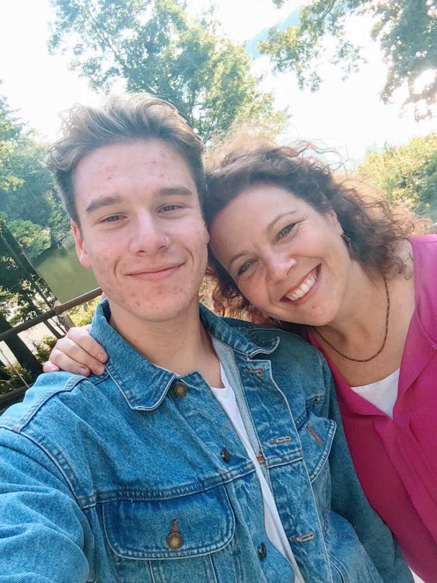 Mom takes a photo with her youngest child before sending him off to college