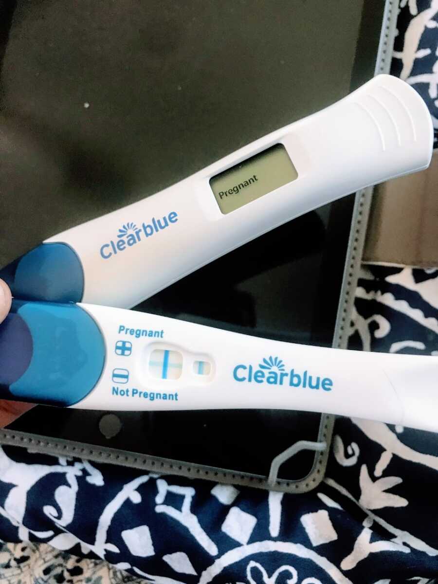Young teen about to start college takes a photo of her two positive pregnancy tests