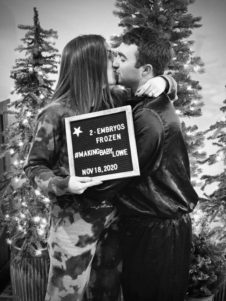 woman and husband kiss after getting 2 frozen embryos