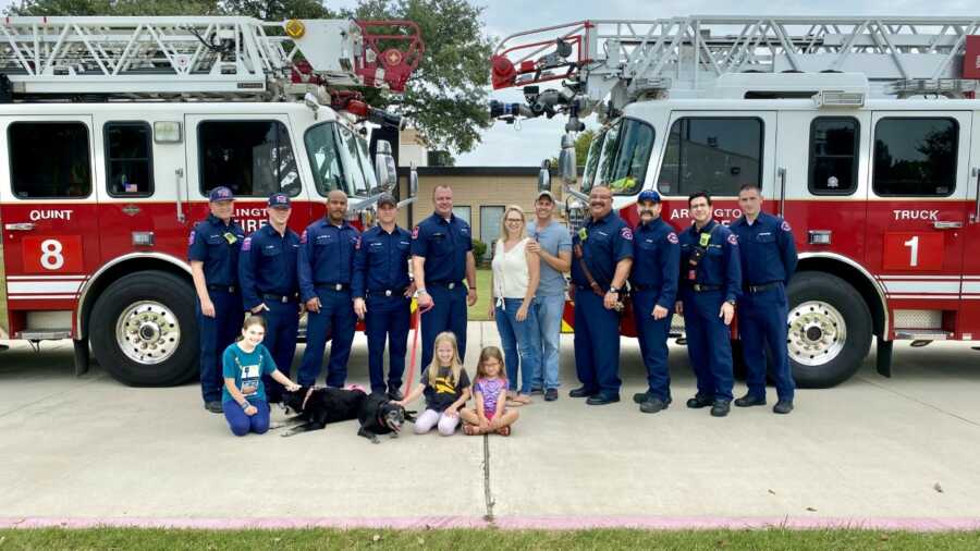 Arlington Fire Crew 8 poses for picture with rescued dog and family.