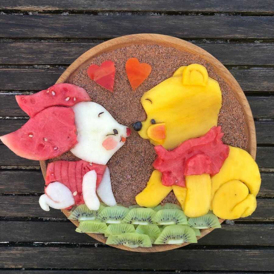 Edible food art fruit platter scene of Winnie the Pooh and Piglet. 