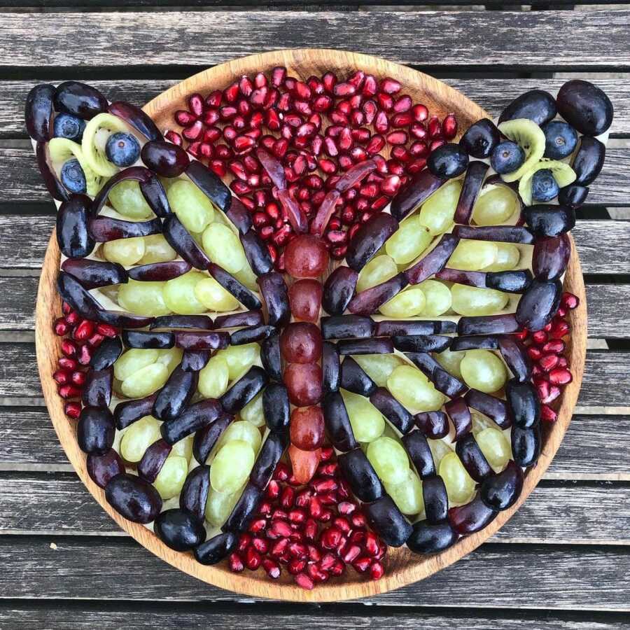 Edible food art fruit platter scene of a butterfly. 