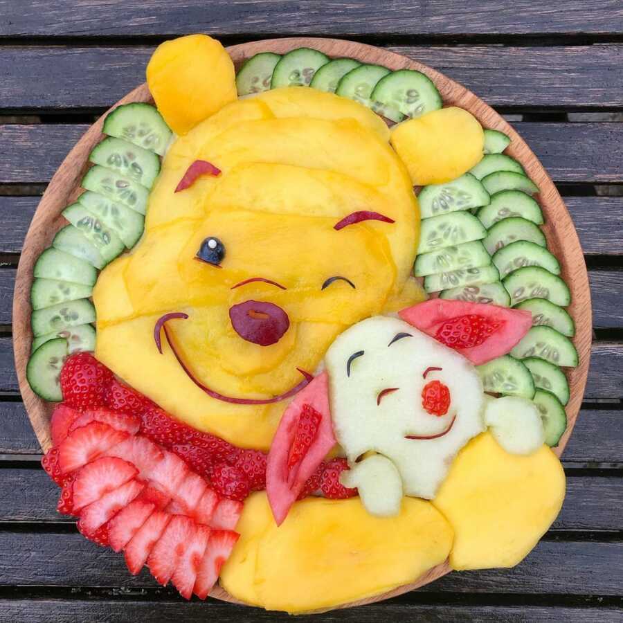 Edible food art fruit platter scene of Winnie the Pooh and Piglet. 