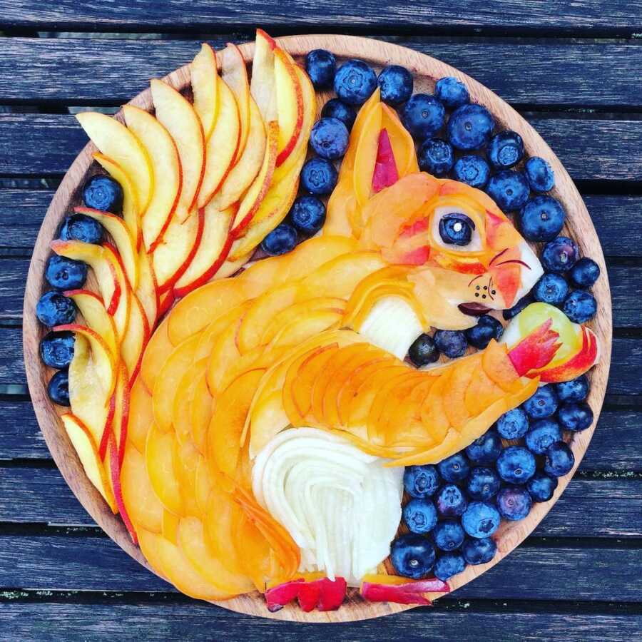 Edible food art fruit platter scene of a squirrel. 