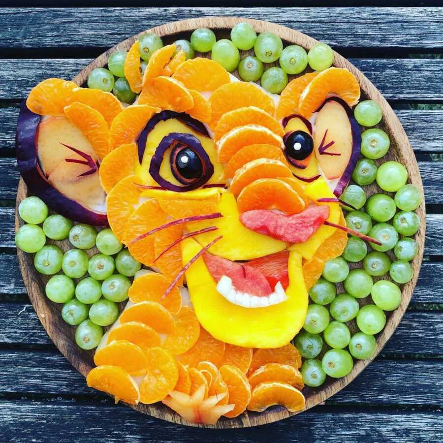 Edible food art fruit platter scene of young Simba from Disney's The Lion King.