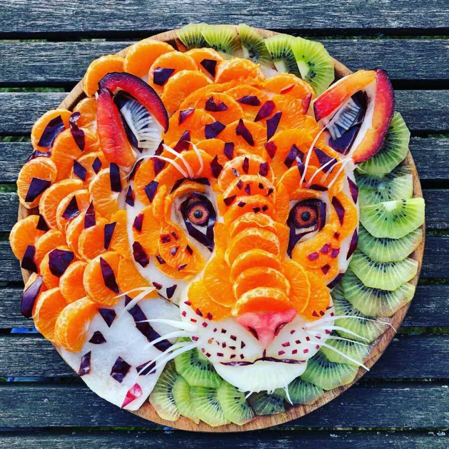 Edible food art fruit platter scene of a cheetah. 