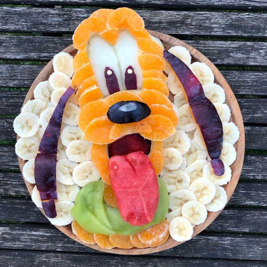 Edible food art fruit platter scene of Disney's Pluto.