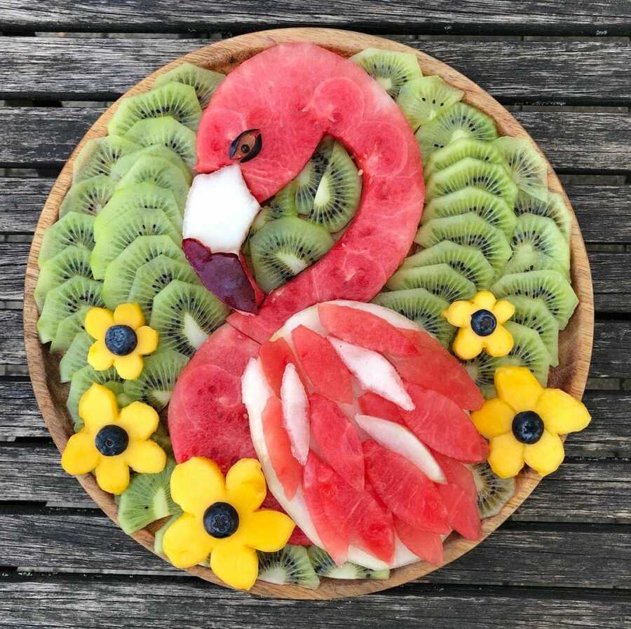 Edible food art fruit platter scene of a pink flamingo. 