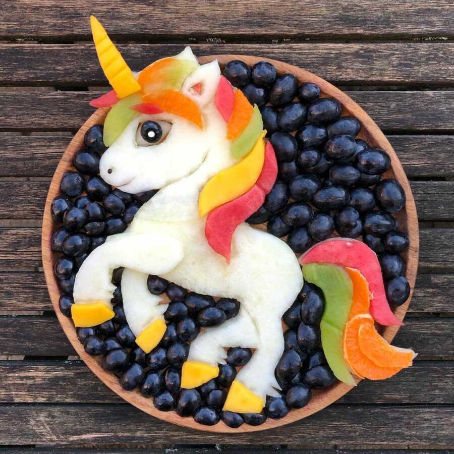 Edible food art fruit platter scene of a unicorn.