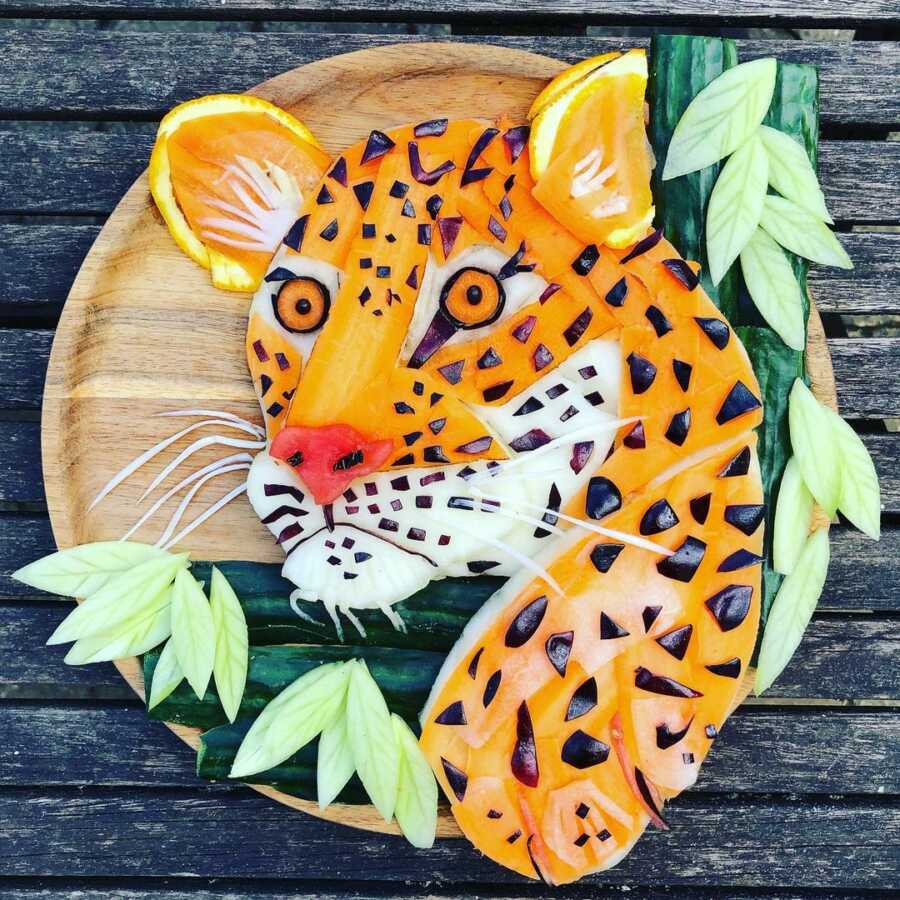 Edible food art platter scene of a cheetah. 