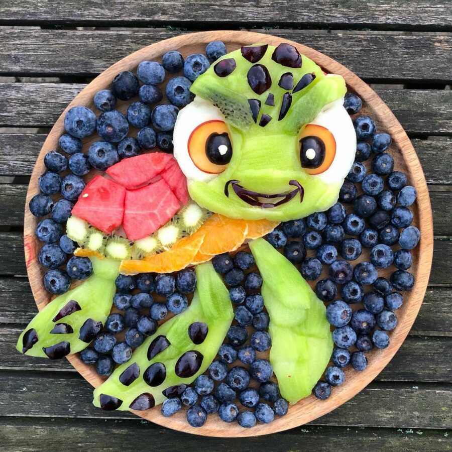 Edible food art fruit platter scene of Squirt, the baby sea turtle, in Disney's Finding Nemo.