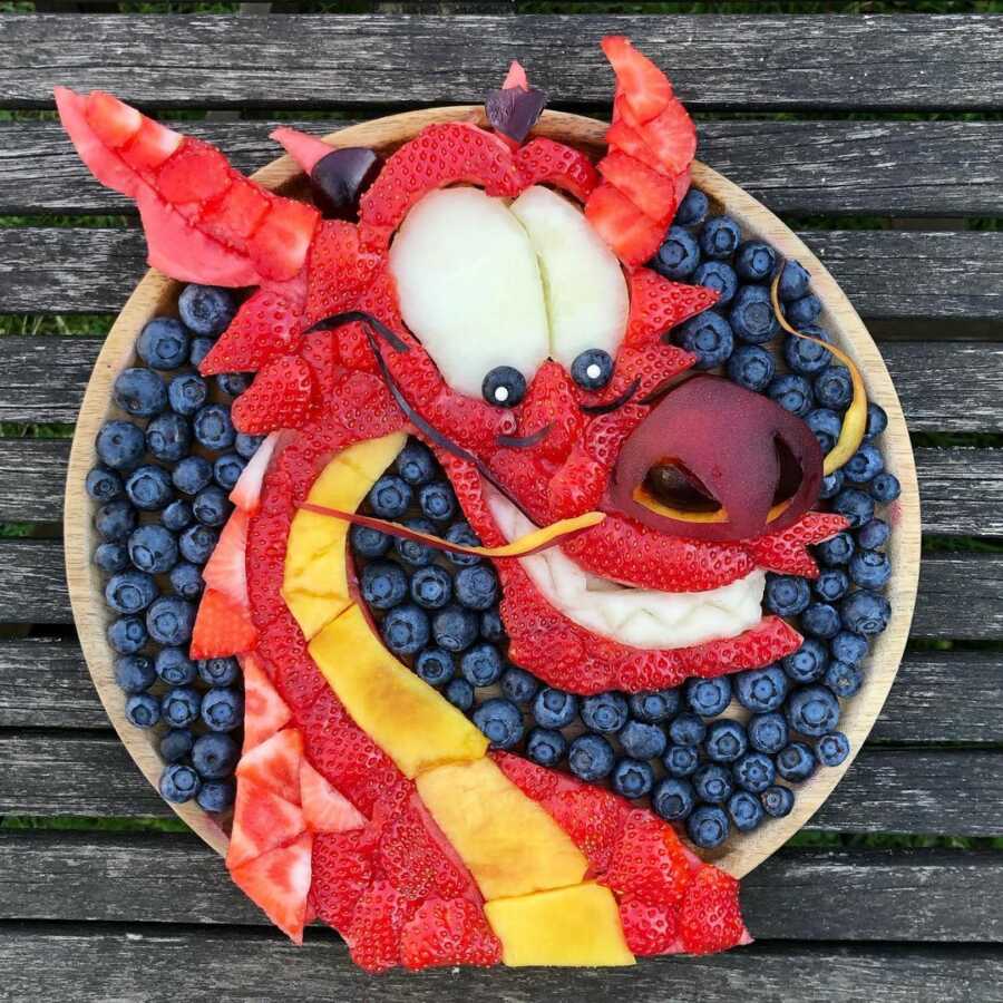 Edible food art fruit platter scene of Mushu from Disney's Mulan.