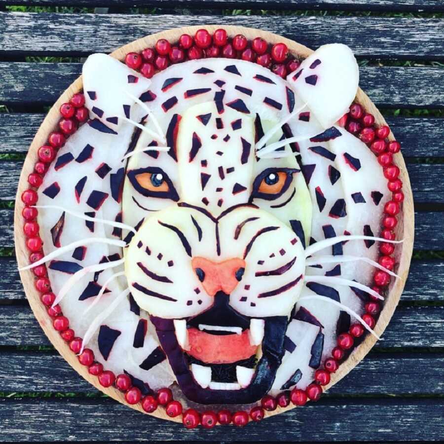 Edible food art fruit platter scene of a white tiger. 