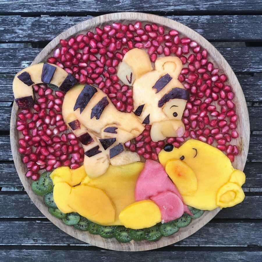 Edible food art fruit platter scene of Tigger and Winnie the Pooh. 