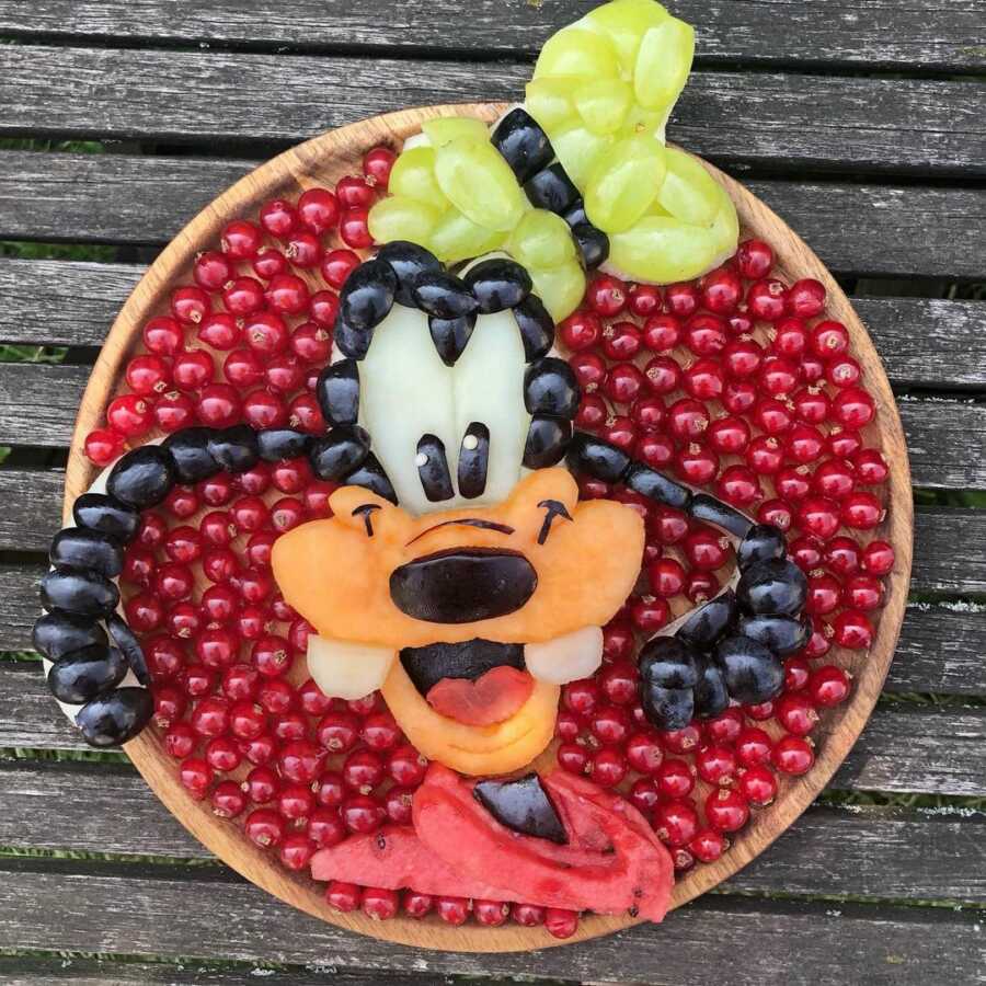 Edible food art fruit platter scene of Disney's Goofy. 