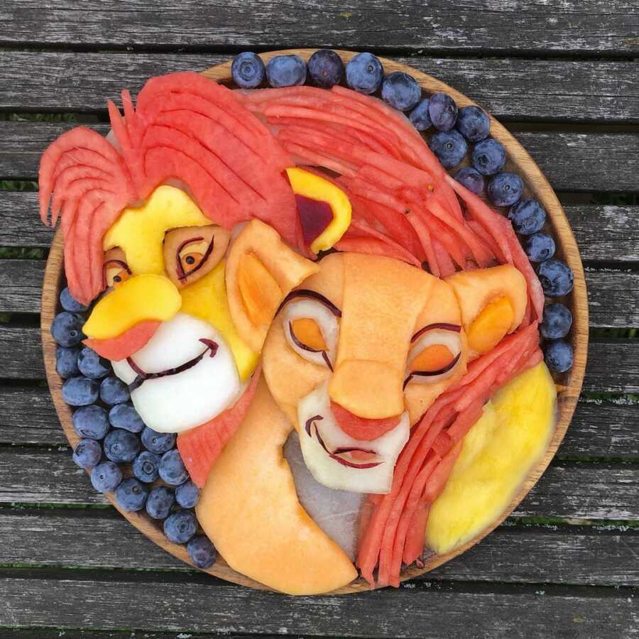 Edible food art fruit platter scene of Simba and Nala from Disney's The Lion King. 