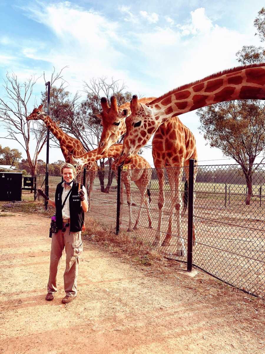 Woman working as a tour guide with giraffes