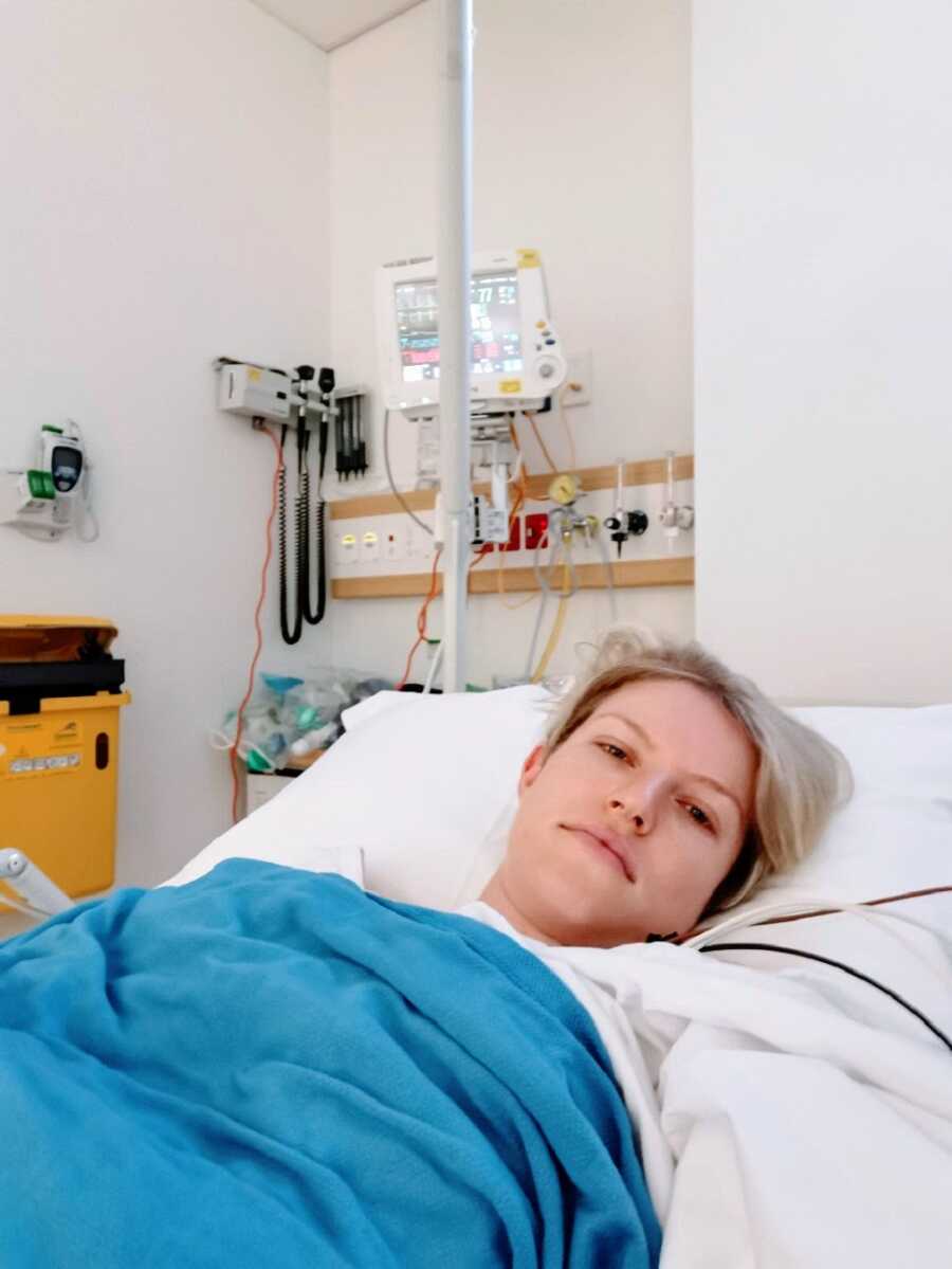 Woman with chronic illness lying in hospital bed