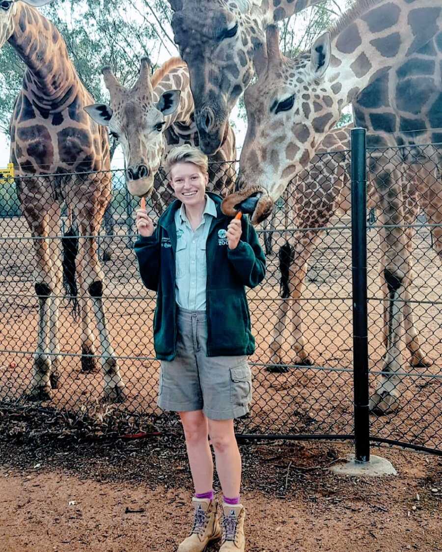 Woman at work as tour guide with giraffes