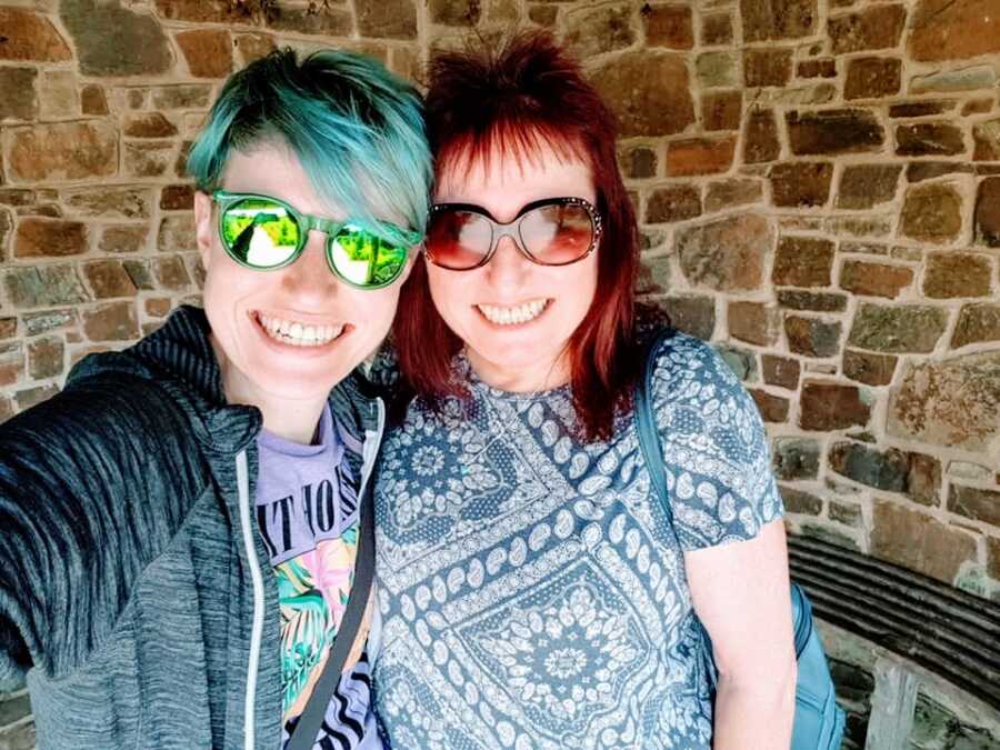 Woman with her mother, both have dyed hair and sunglasses