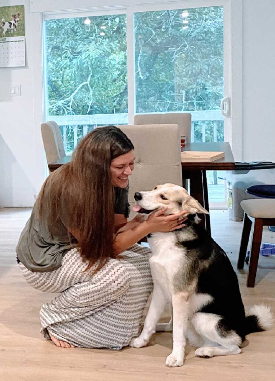 Woman struggling with mania pets big dog