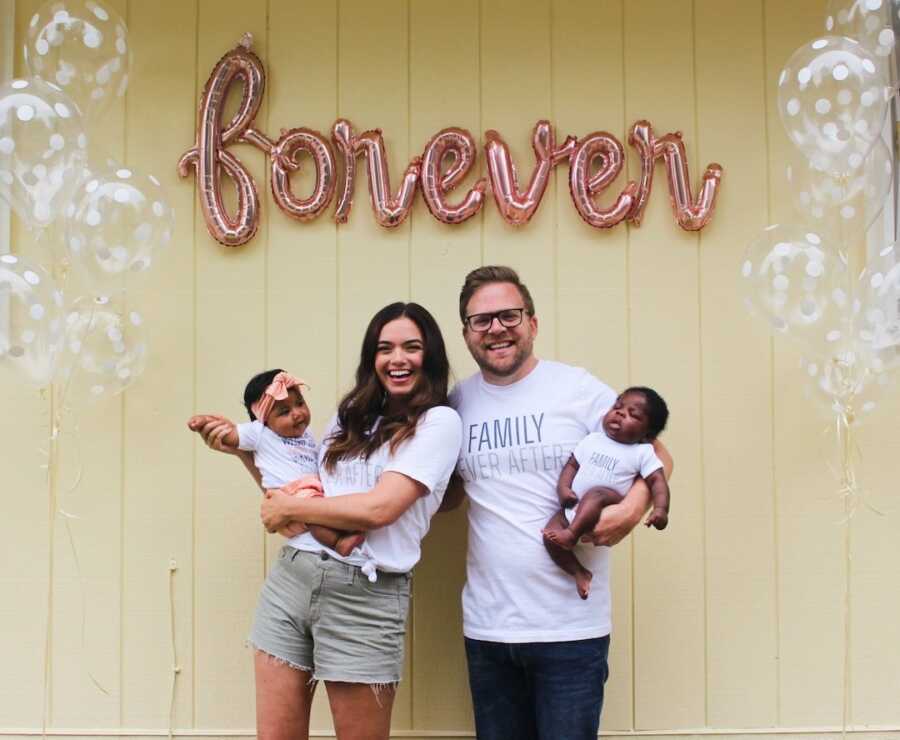 mother and husband holding two new adoptive babies