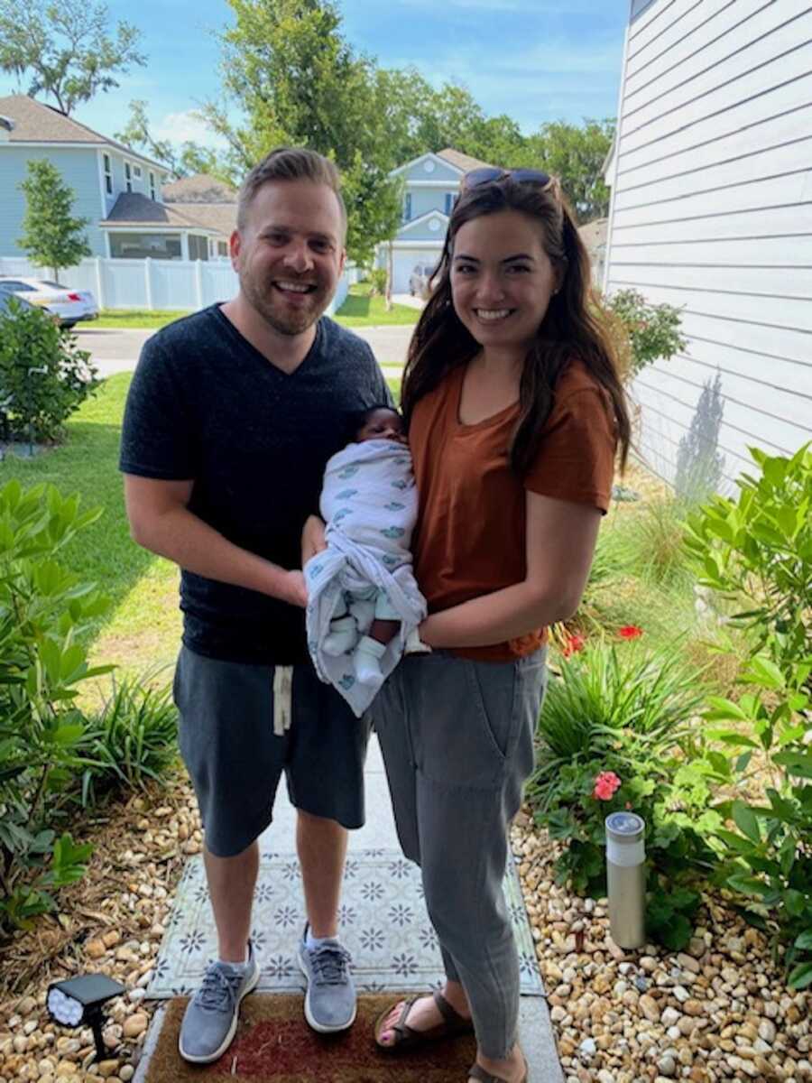 mom and husband holding new adoptive baby boy