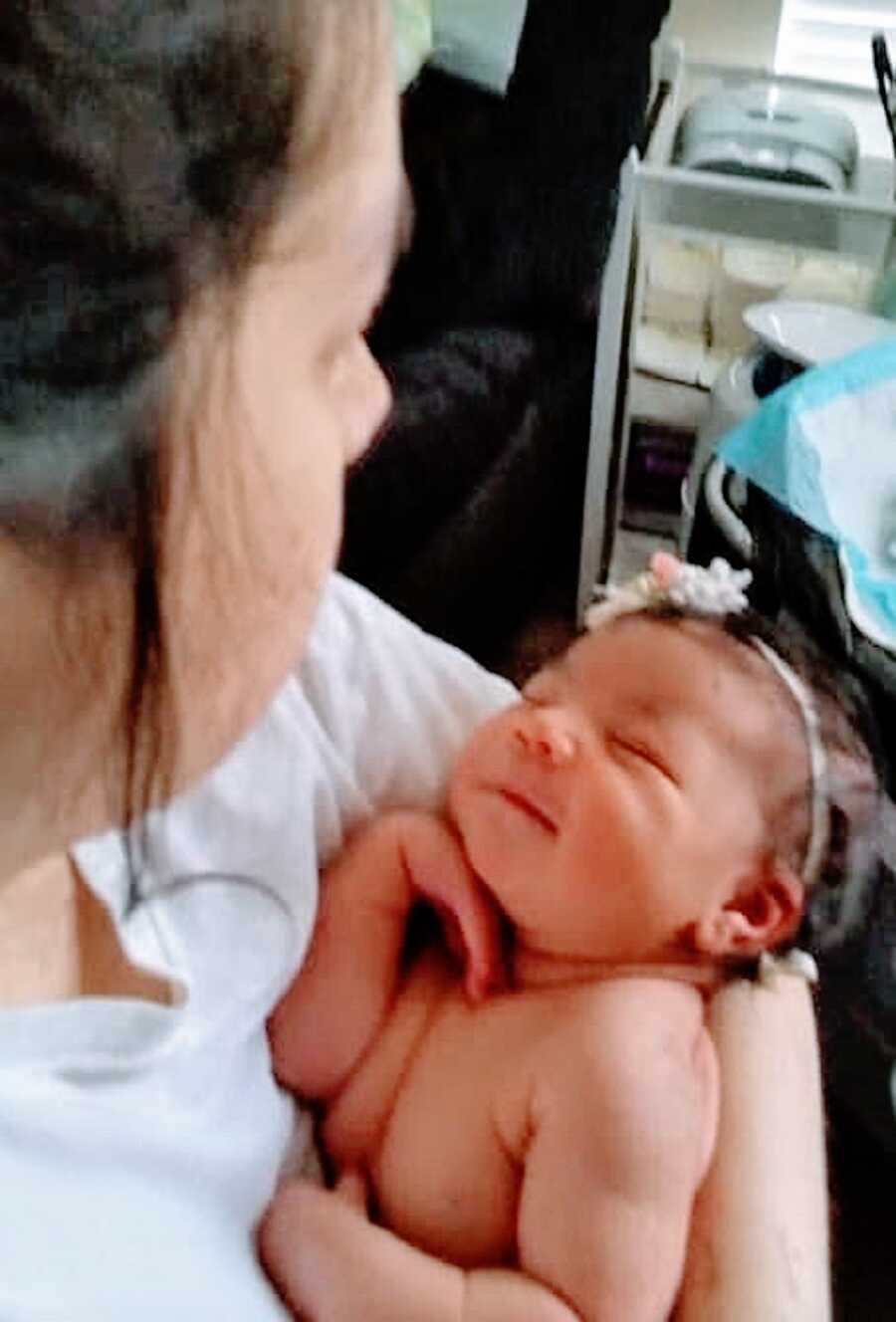 Mother holds baby girl in her arms