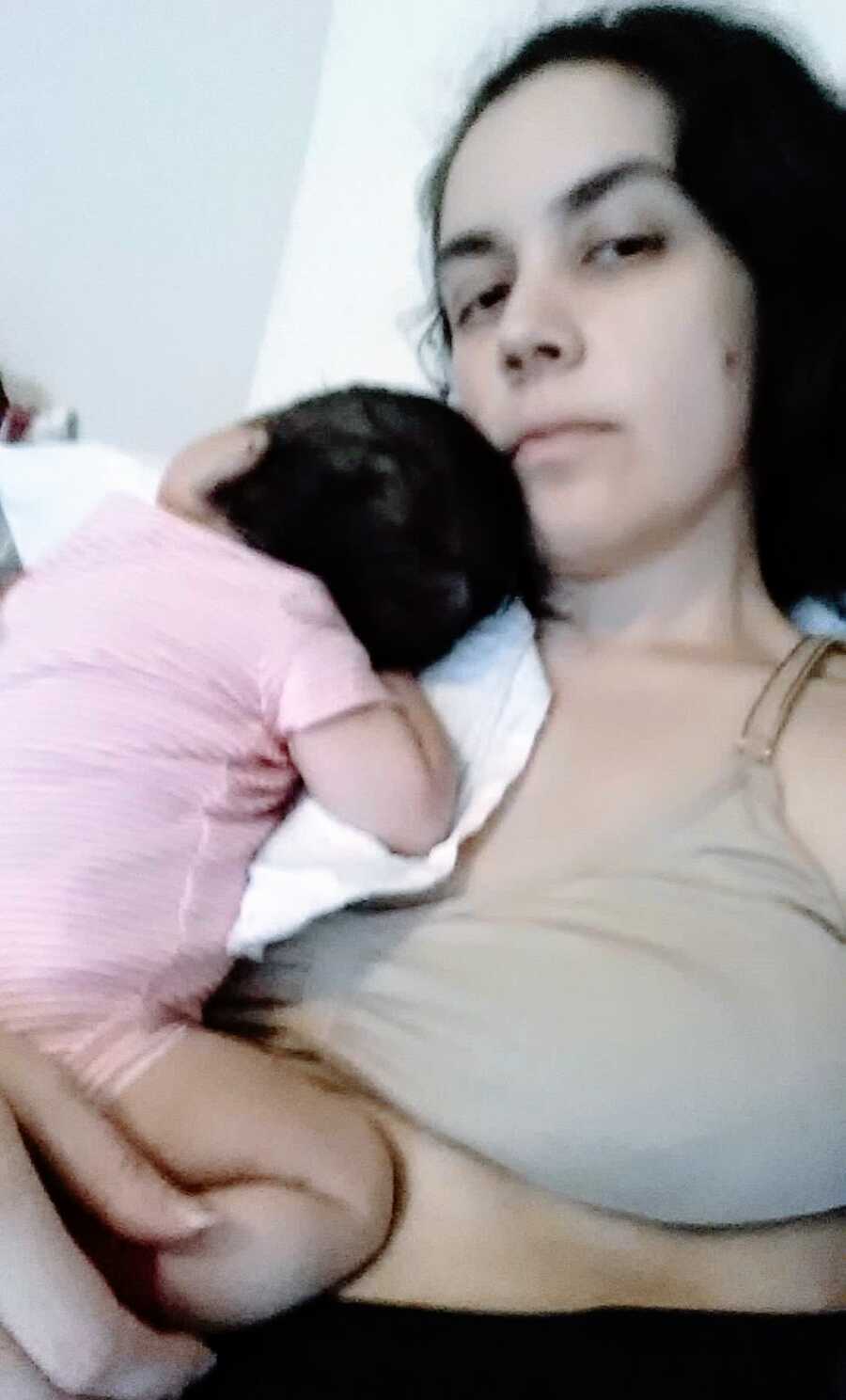 Mother with baby girl lying on her chest