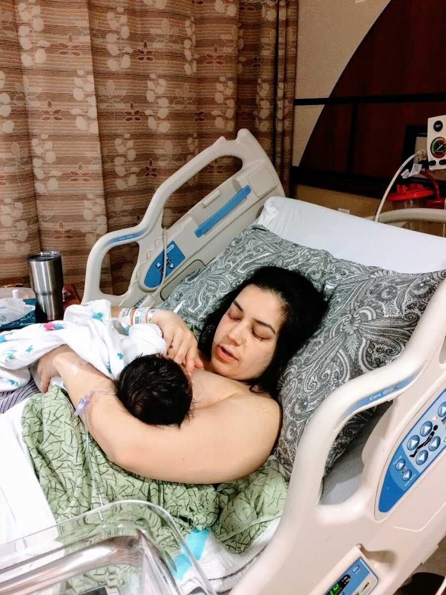 Mother lying in hospital bed with baby