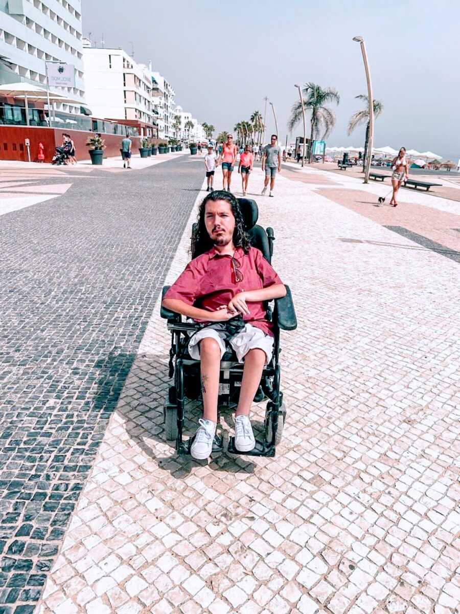 Man in wheelchar outside near a beach