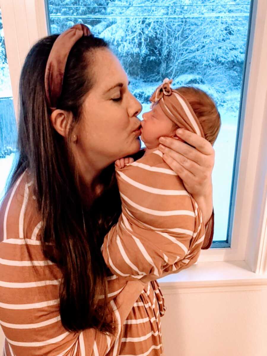 mom kisses child that will be adopted