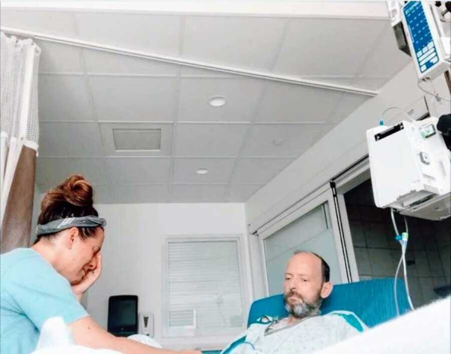 widow cries with husband in hospital bed