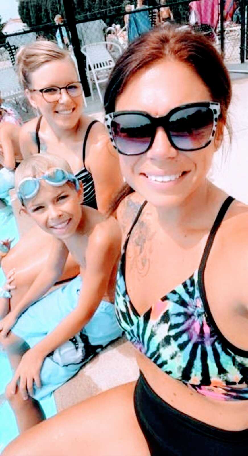 Biological mom and bonus mom take a selfie at the pool with their shared son
