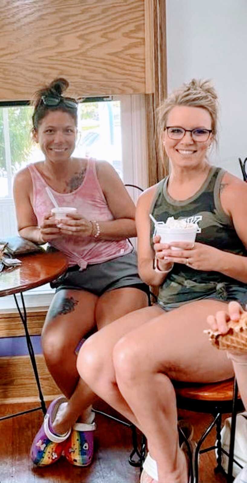Two friends and co-parents take a photo together while enjoying ice cream on a hot summer day
