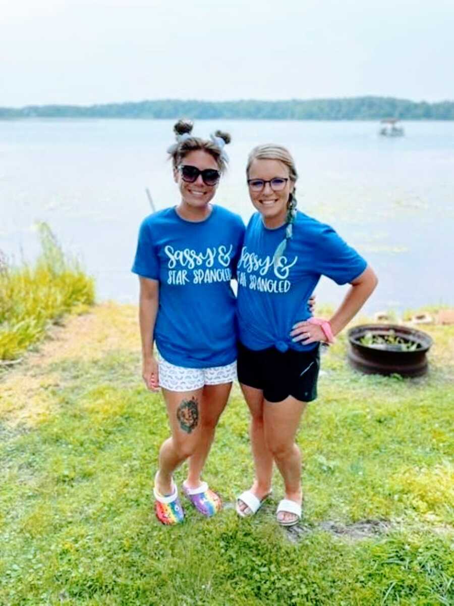 Two moms take a photo together on the Fourth of July, wearing matching shirts that say "Sassy & Star Bangled"