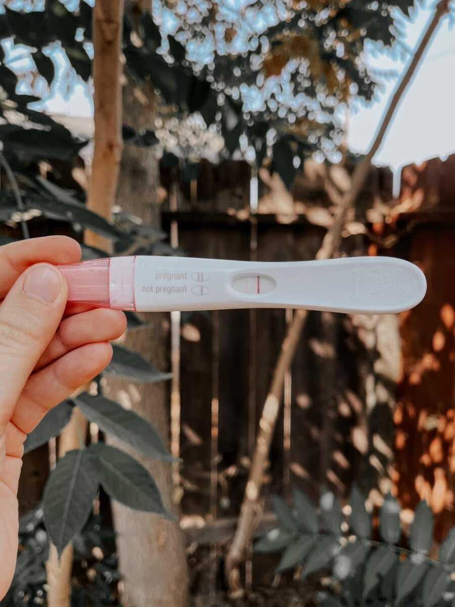 Woman pregnant after a tubal ligation takes a photo of a very faint positive pregnancy test