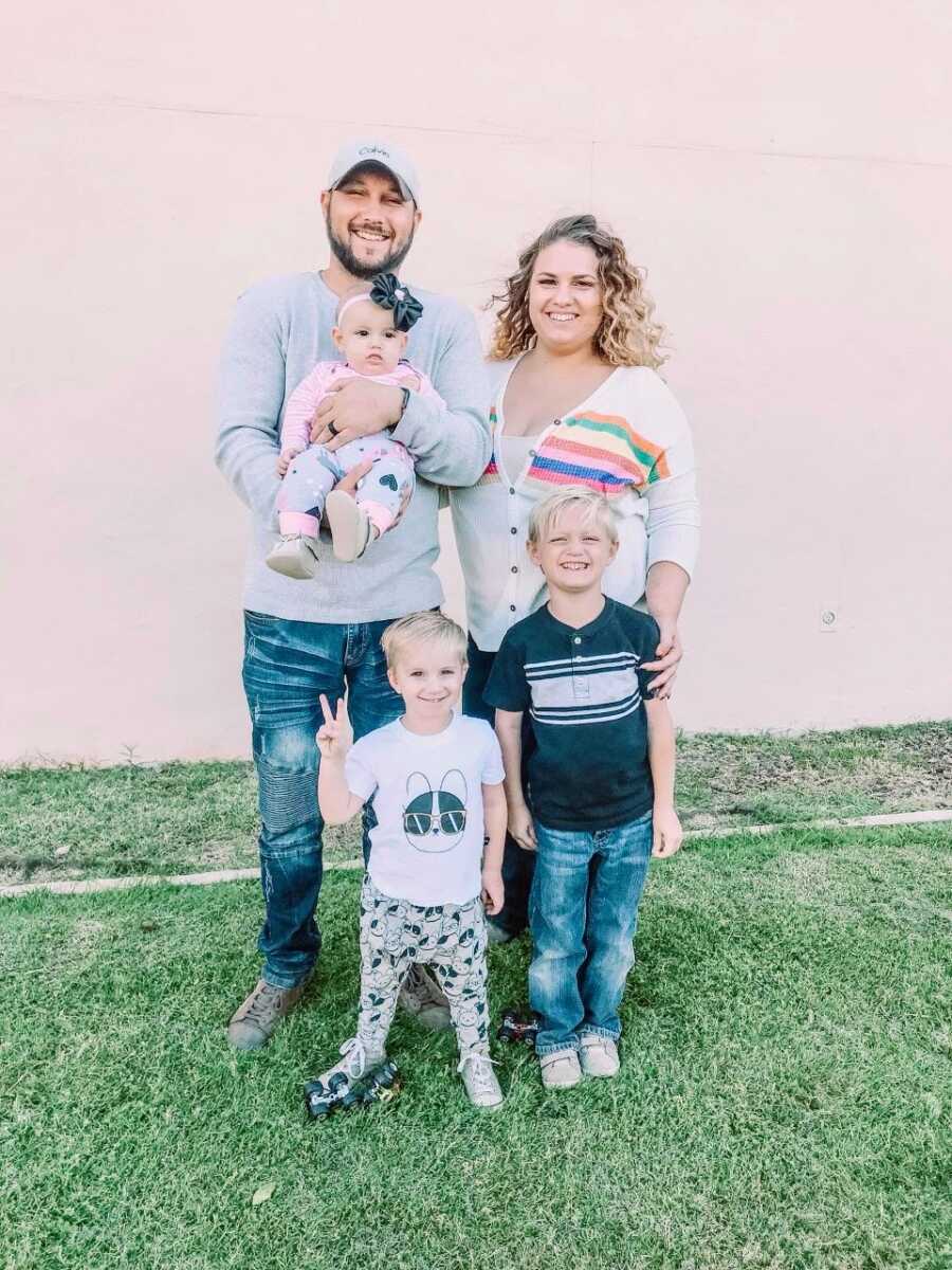 Family of five take a group shot together while enjoying family time at the park