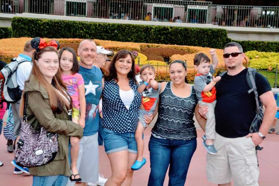 Family take a group photo with their children while at Disneyland in California