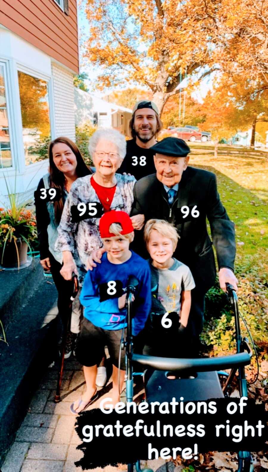 Woman takes a photo with her grandparents, husband, and kids while visiting family