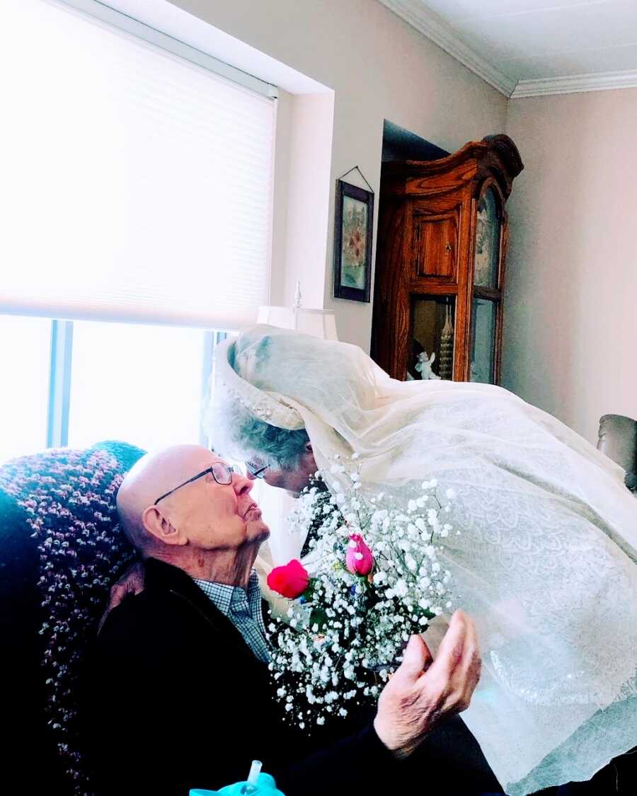 Elderly couple go in for a kiss while celebrating their 75th wedding anniversary