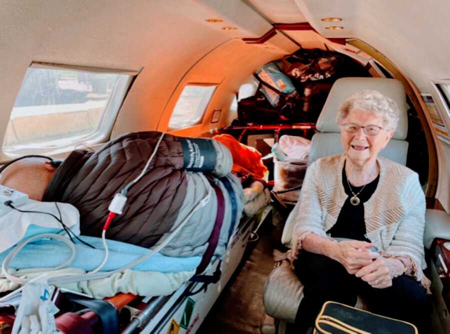 Woman smiles while being life-flighted with her husband to their daughter's house where they can spend the rest of their days together