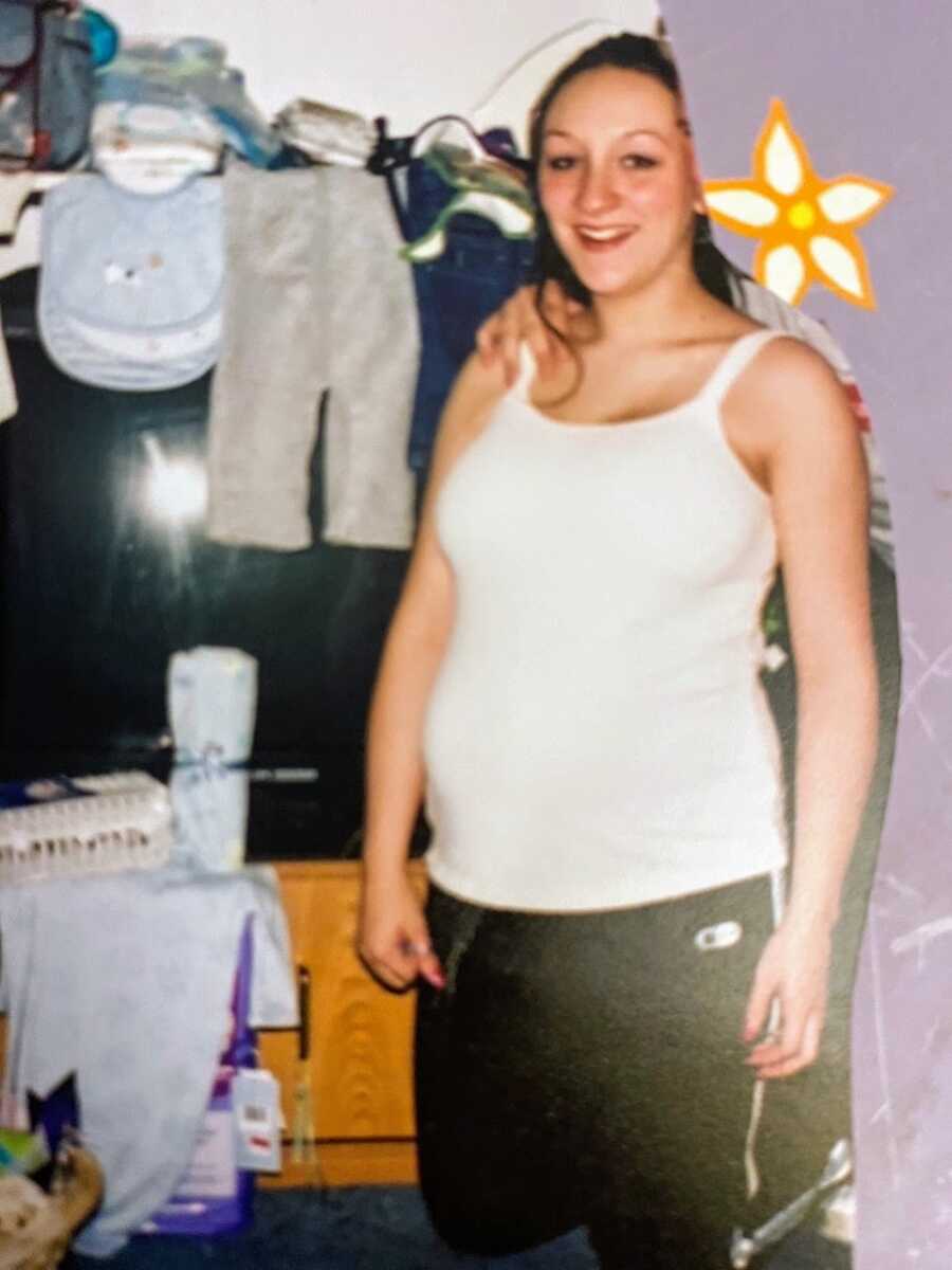 Teen girl pregnant at 14 smiles for a photo at her baby shower