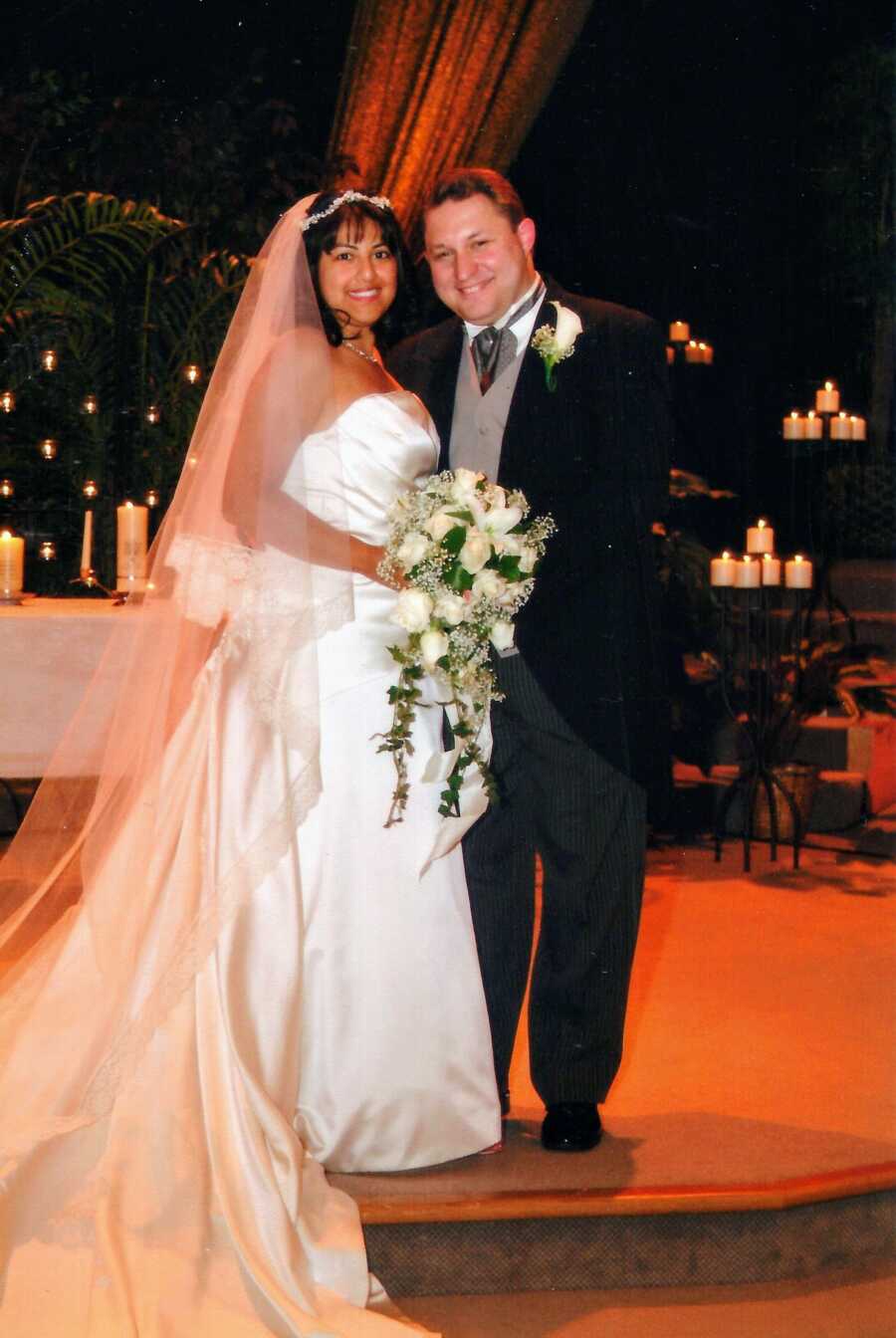 Happy newlywed couple smile big during their wedding reception