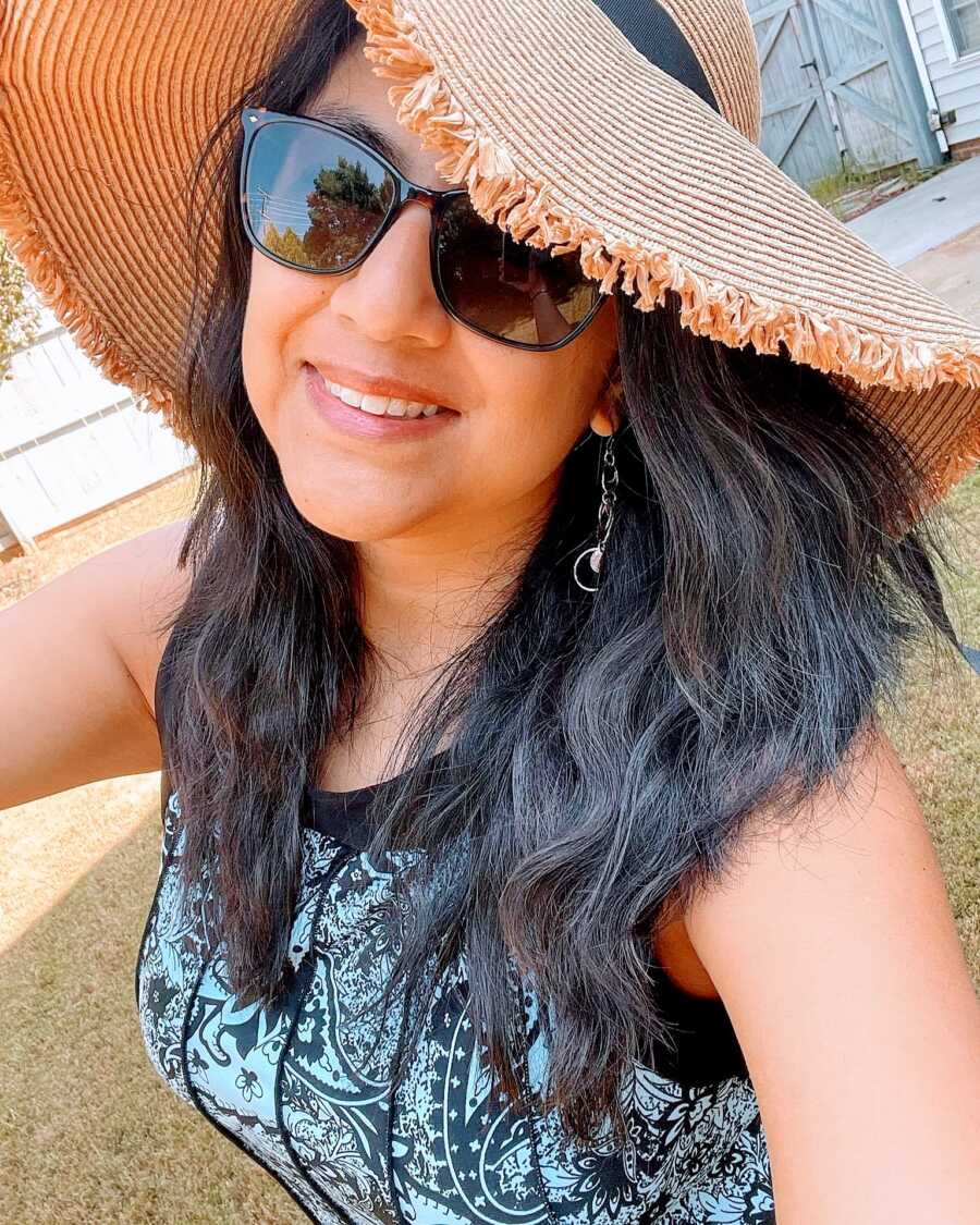 Proud Mexican woman takes a selfie, wearing sunglasses and a sunhat while enjoying some warm weather outside