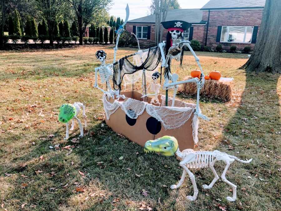 Couple create creative pirate scene with skeleton decorations for Halloween