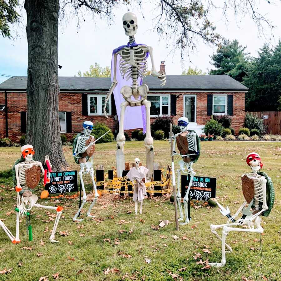 Couple celebrating Halloween with daily skeleton yard displays use them to reenact a scene from Teenage Mutant Ninja Turtles