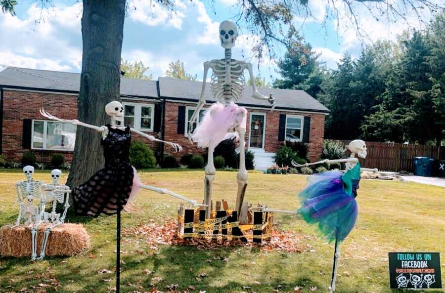 Couple celebrating Halloween with daily skeleton yard displays dress them up in ballet costumes