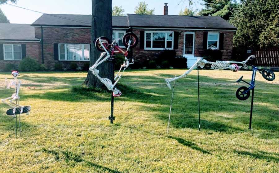Couple use Halloween skeleton decorations to create a BMX freestyle yard scene for the Summer Olympics