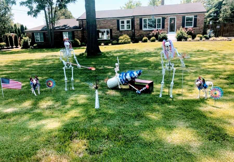 Couple create whimsical 4th of July scene with skeleton decorations in their front yard